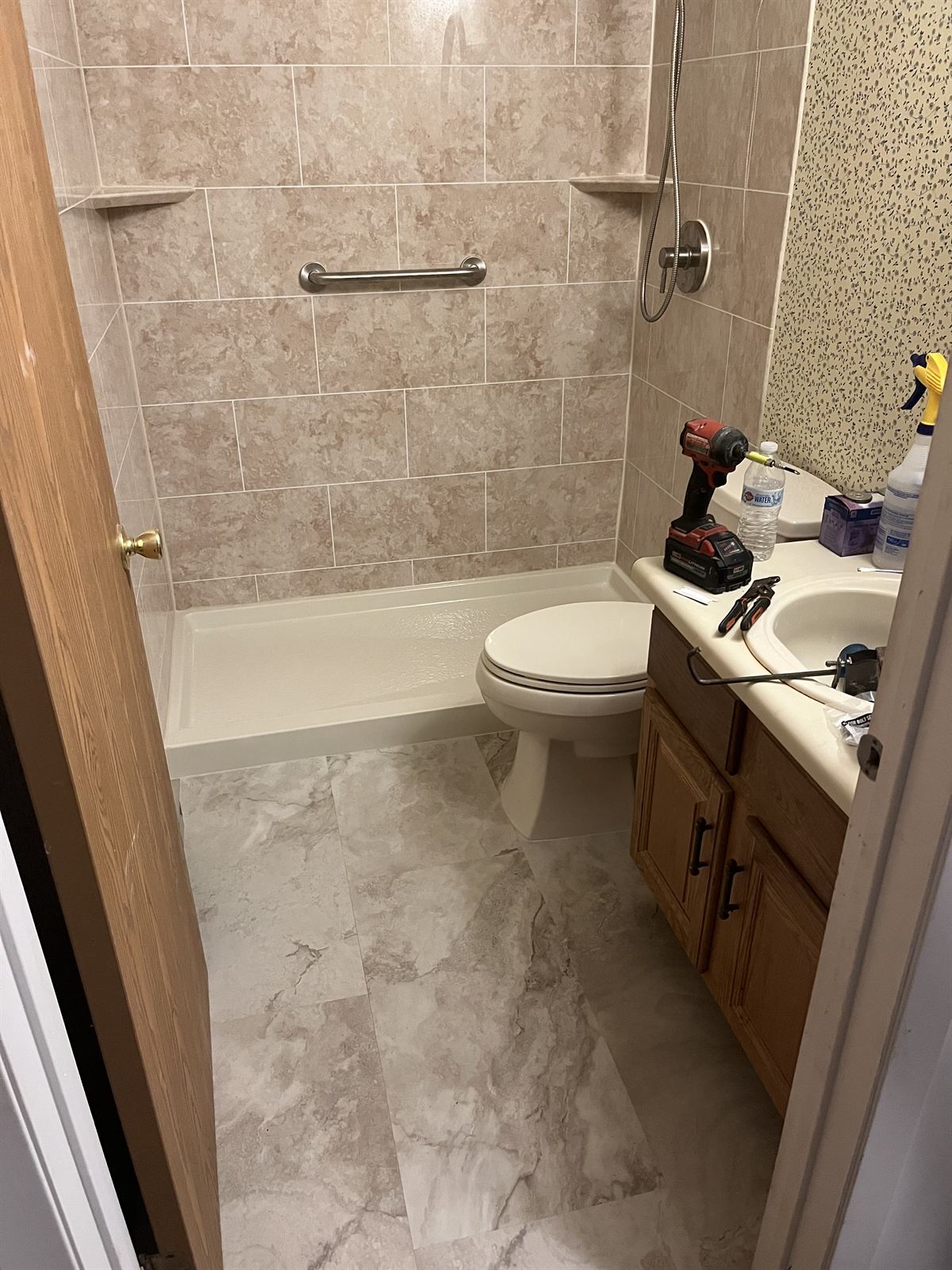 Complete bathroom refresh with stone look acrylic shower and new tile style flooring
