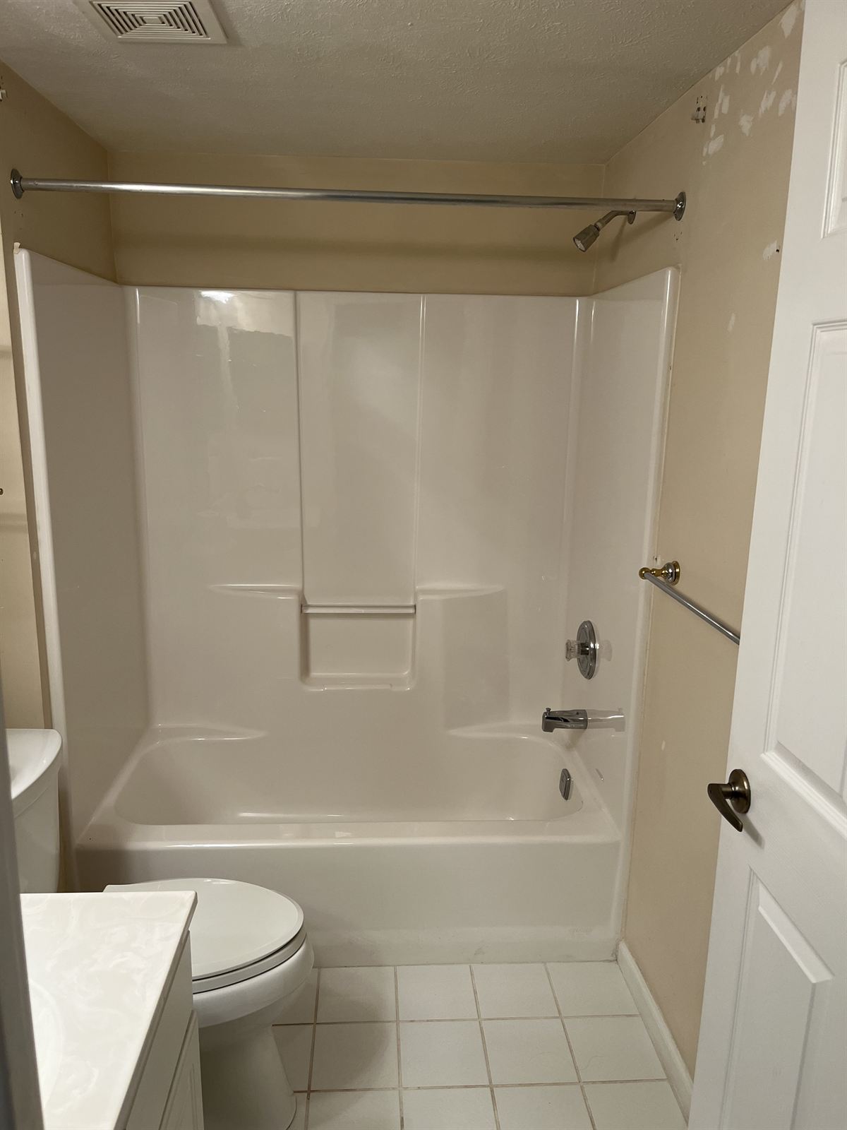 Before: plain cream fiberglass tub surround