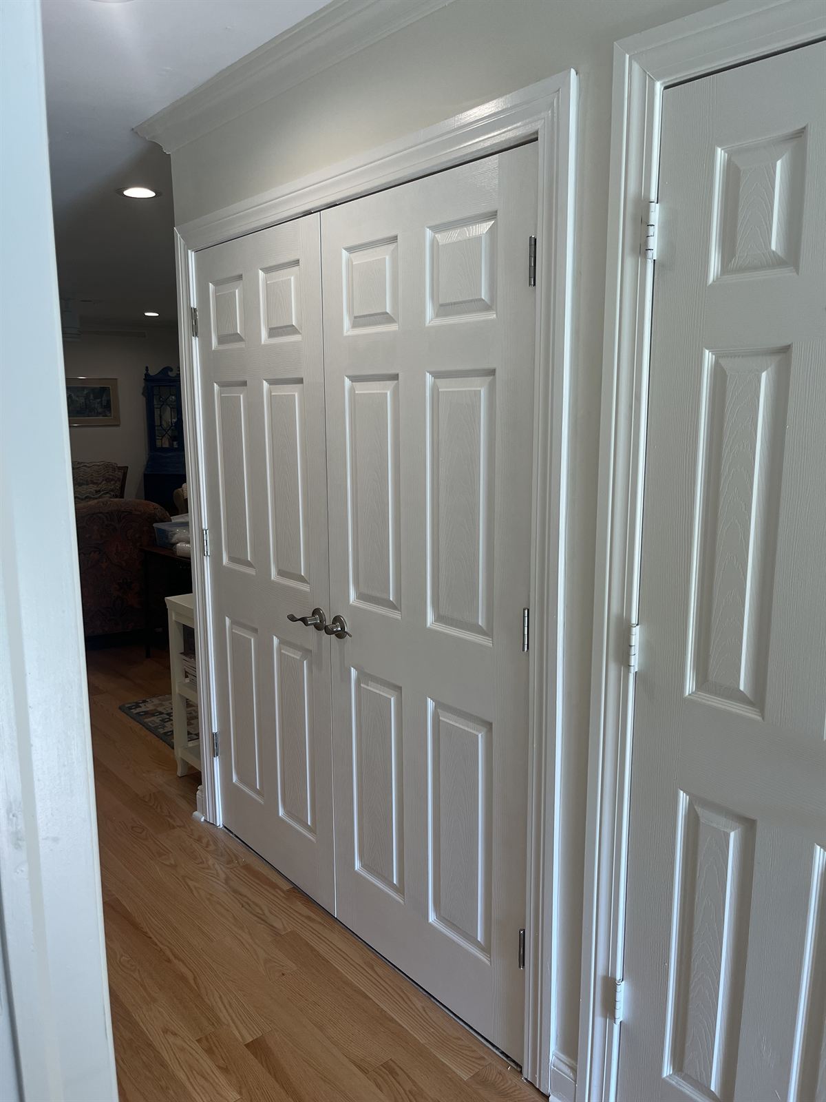 After: new white paneled french doors with satin nickel levers, cased and trimmed