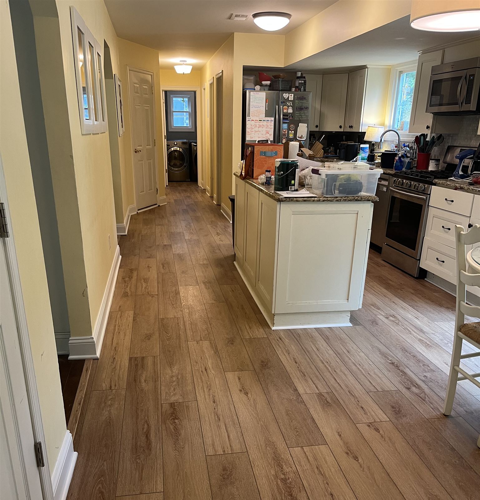 After: new light oak plank flooring running through the kitchen and hallway