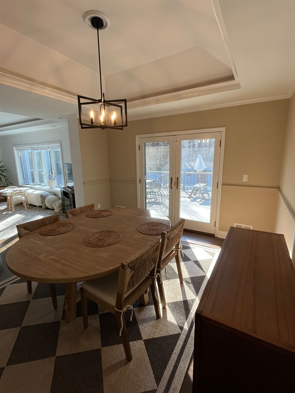 A dining room repainted by Mr. Home Helper in warm tan with crisp white trim