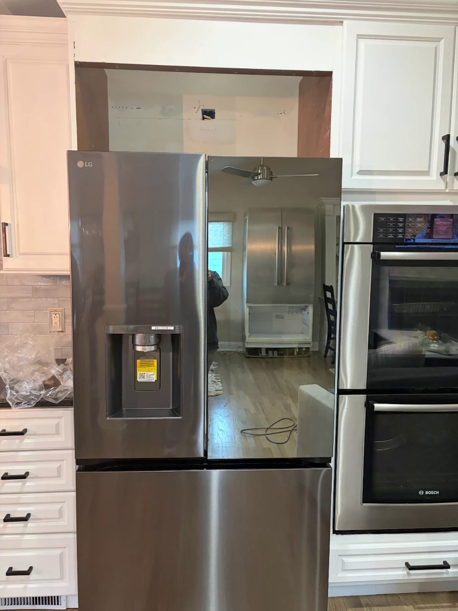 Before: a new smaller fridge with an empty unfinished opening above it