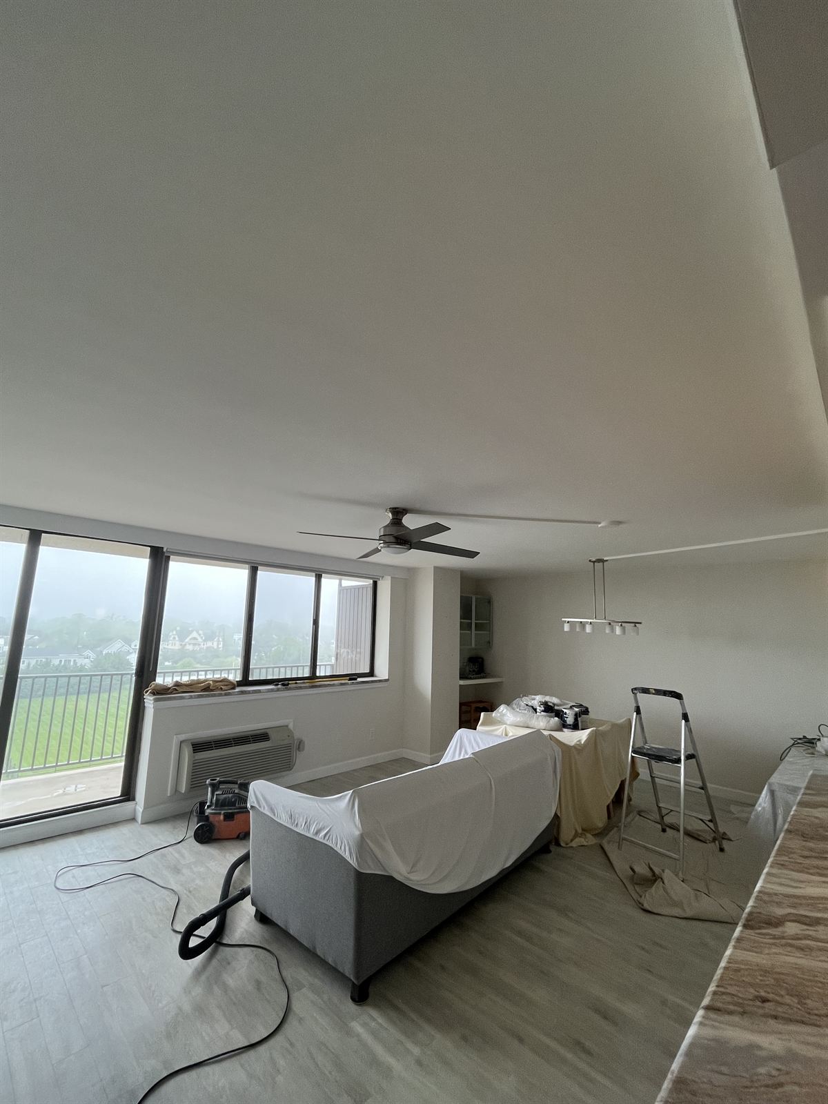 After: smooth freshly painted ceiling with fan and light fixture