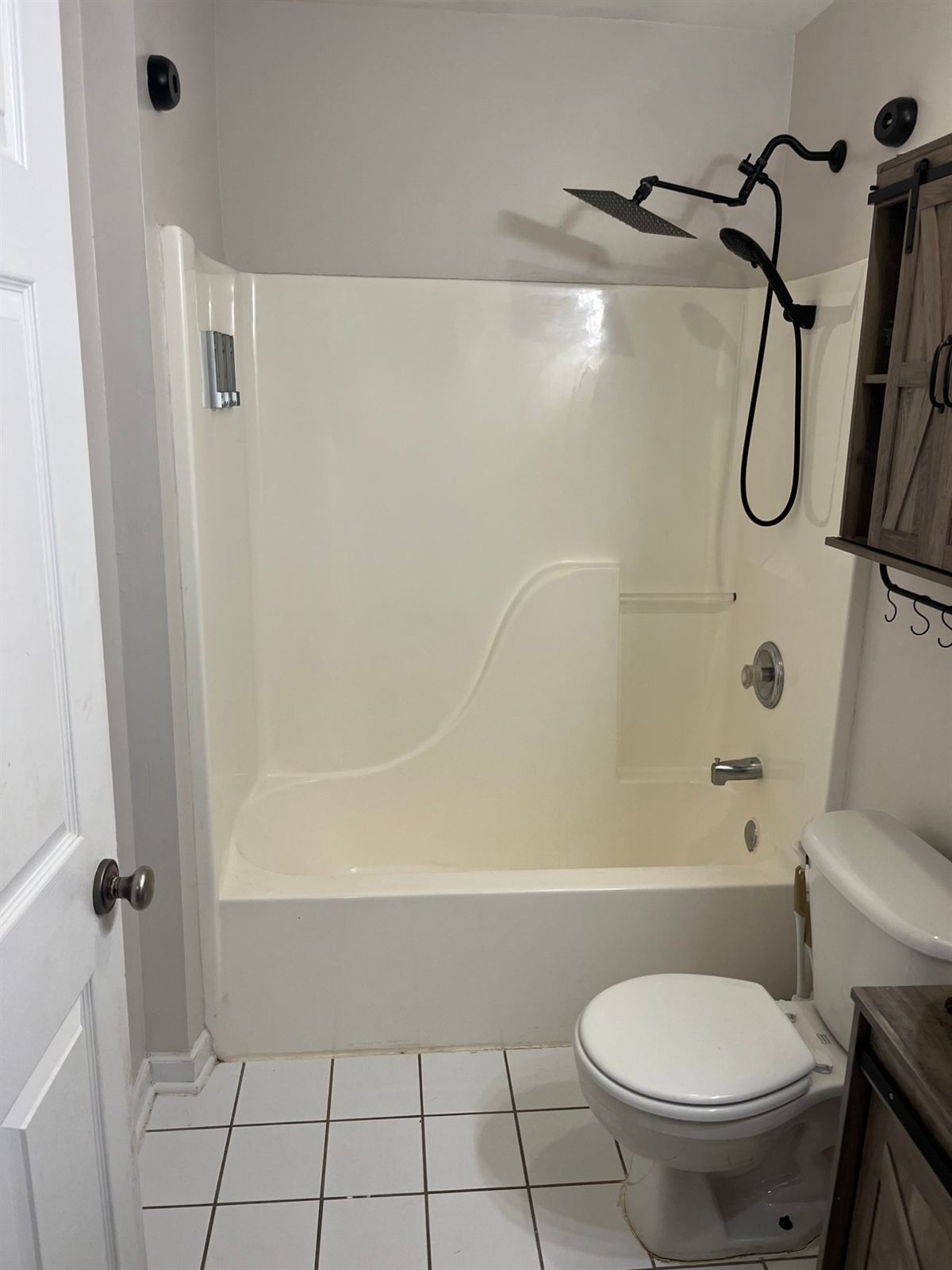 Before: one piece cream acrylic tub and shower surround